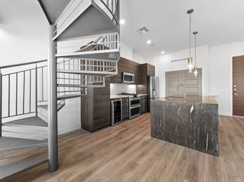 a kitchen with a staircase and a counter top in a house at Scottsdale Grand, Scottsdale, AZ